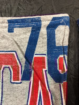 The front corner of a T-shirt blanket bound with the birthing method.