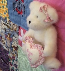 Stuffed bear on memory quilt by Too cool T-shirt quilts